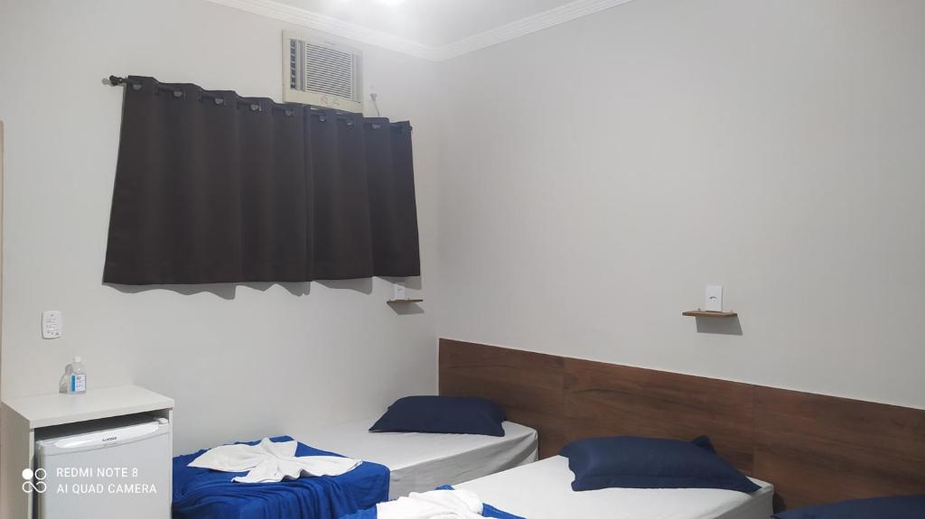Postel nebo postele na pokoji v ubytování Pousada Quarto com frigobar,ar e garagem gratuita