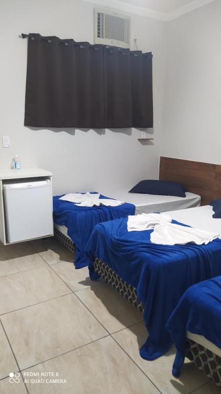 Postel nebo postele na pokoji v ubytování Pousada Quarto com frigobar,ar e garagem gratuita