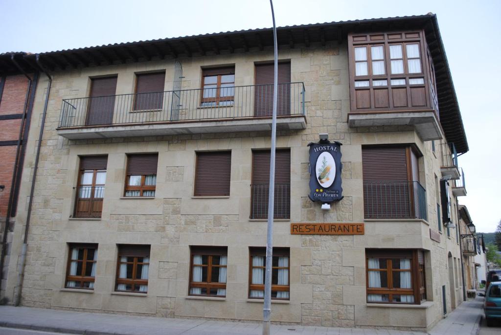 a building with a clock on the side of it at Hotel Rural La Corte de los Pinares in Vinuesa