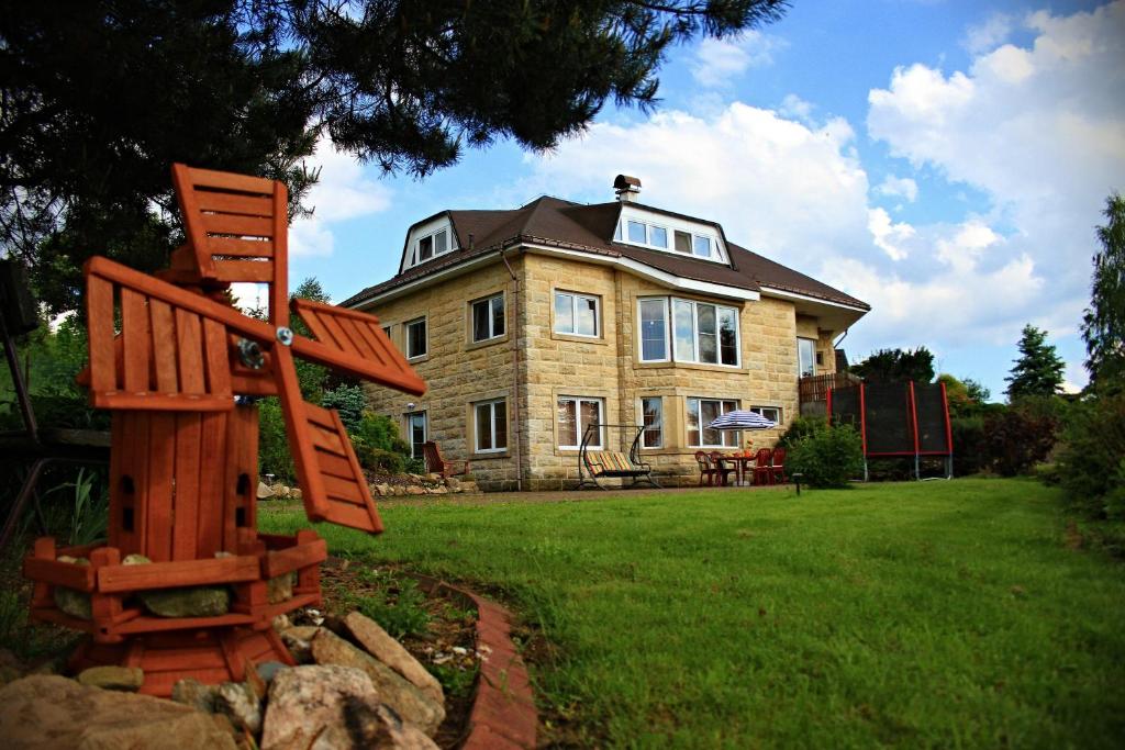 a house with a wooden chair in front of it at Apartma Marcella Liberec in Liberec