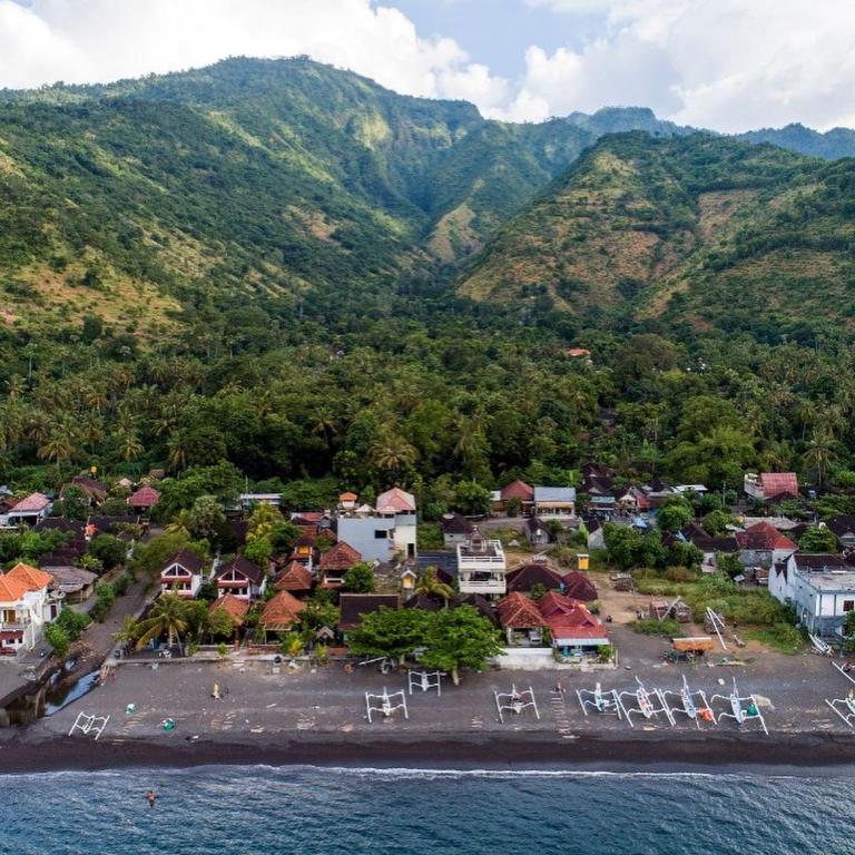 an aerial view of a small town on the water at Solaluna Beach Homestay in Amed