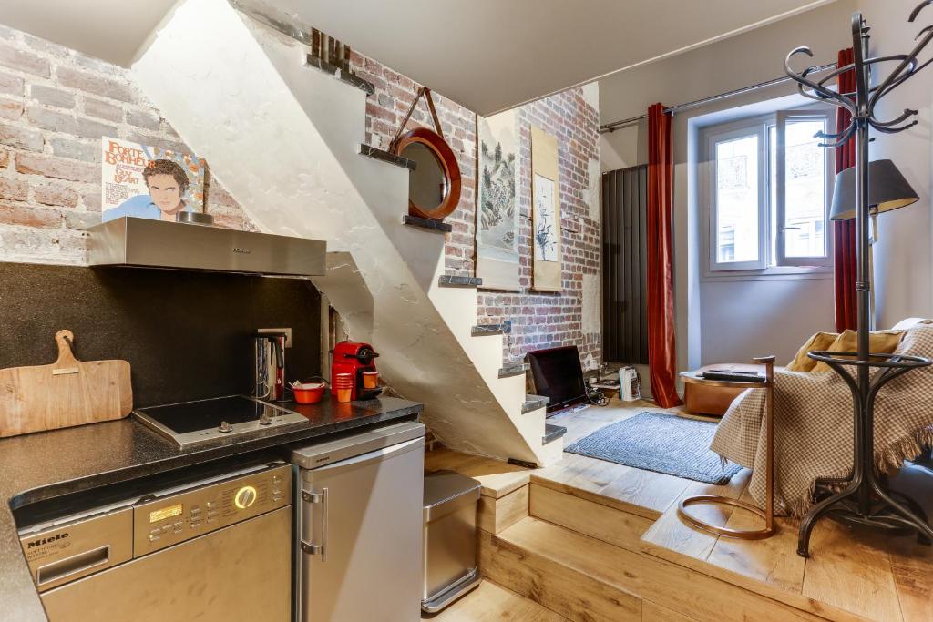 een keuken met een wastafel en een trap bij Bail Mobilité Appartement, Place Vendome, Opera in Parijs