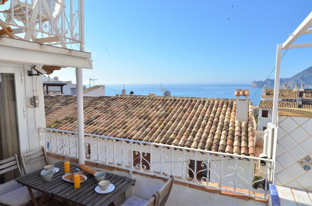 a balcony with a table and a view of the ocean at Idyllic old town house in Altea by NRAS in Altea