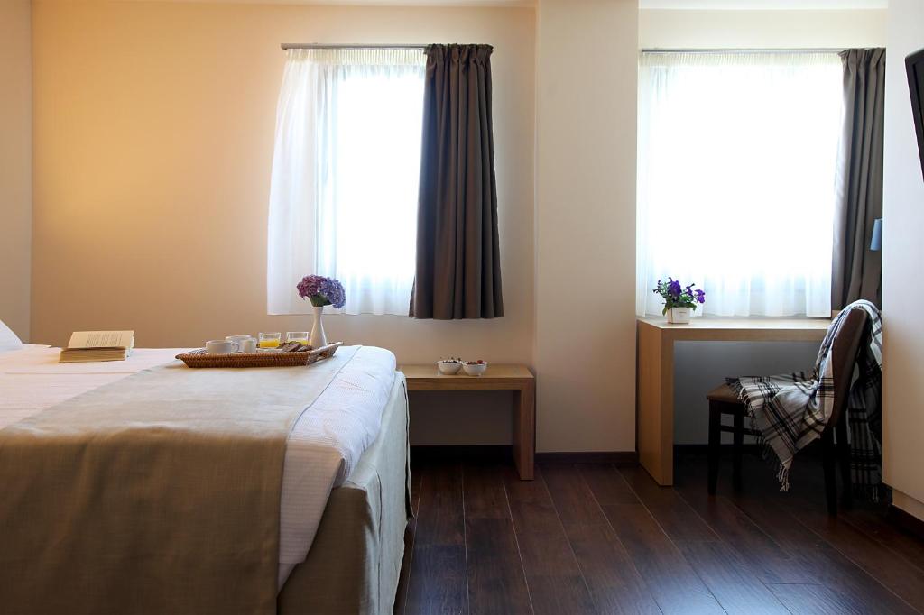Giường trong phòng chung tại Theta Hotel Pelion