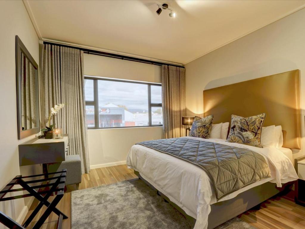 a bedroom with a large bed and a large window at Harvil House in George