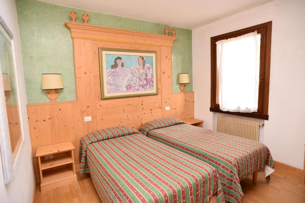 Postel nebo postele na pokoji v ubytování Albergo Da Gildo