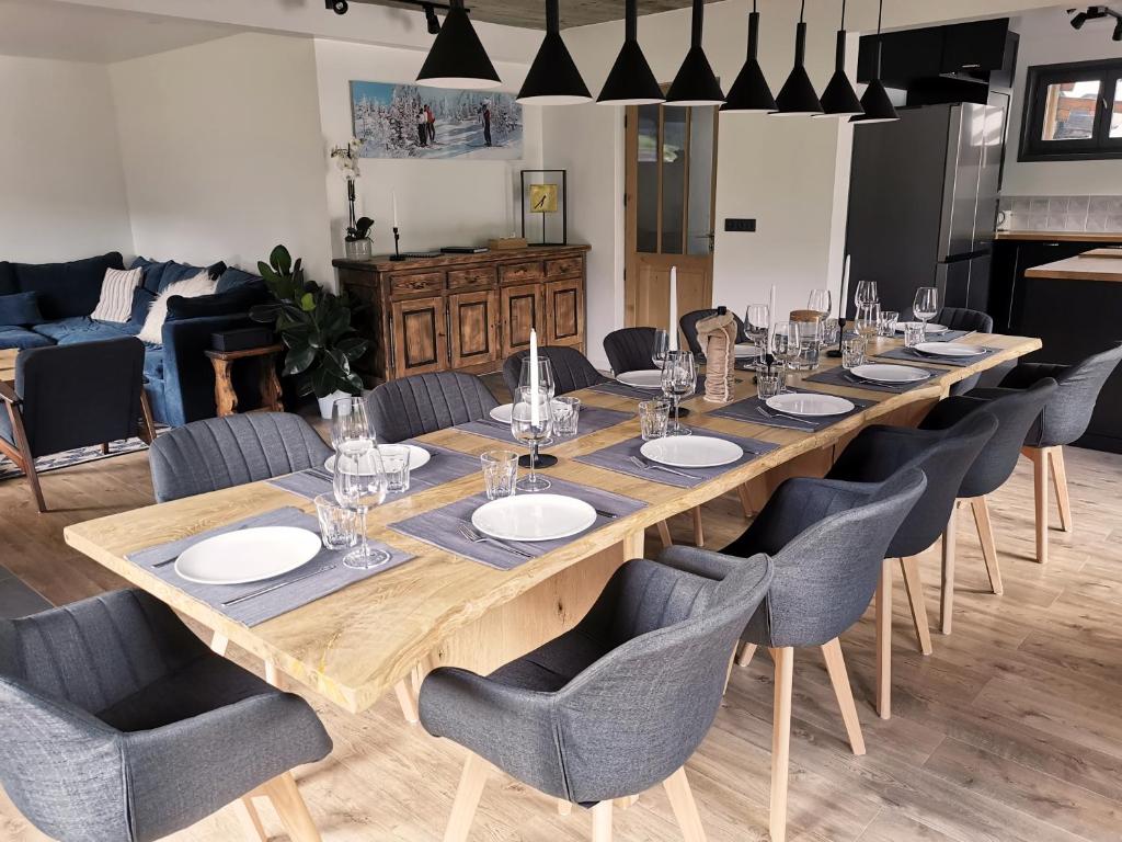 a large wooden table with chairs and a long table at Chalet Domisiladoré - chalet haut de gamme pour 10 adultes et 2 enfants à Châtel in Châtel