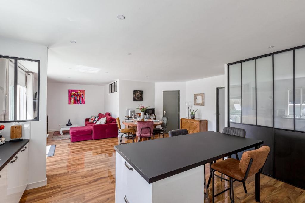 a kitchen and living room with a table and chairs at Maison Dany in Salles-sur-Mer