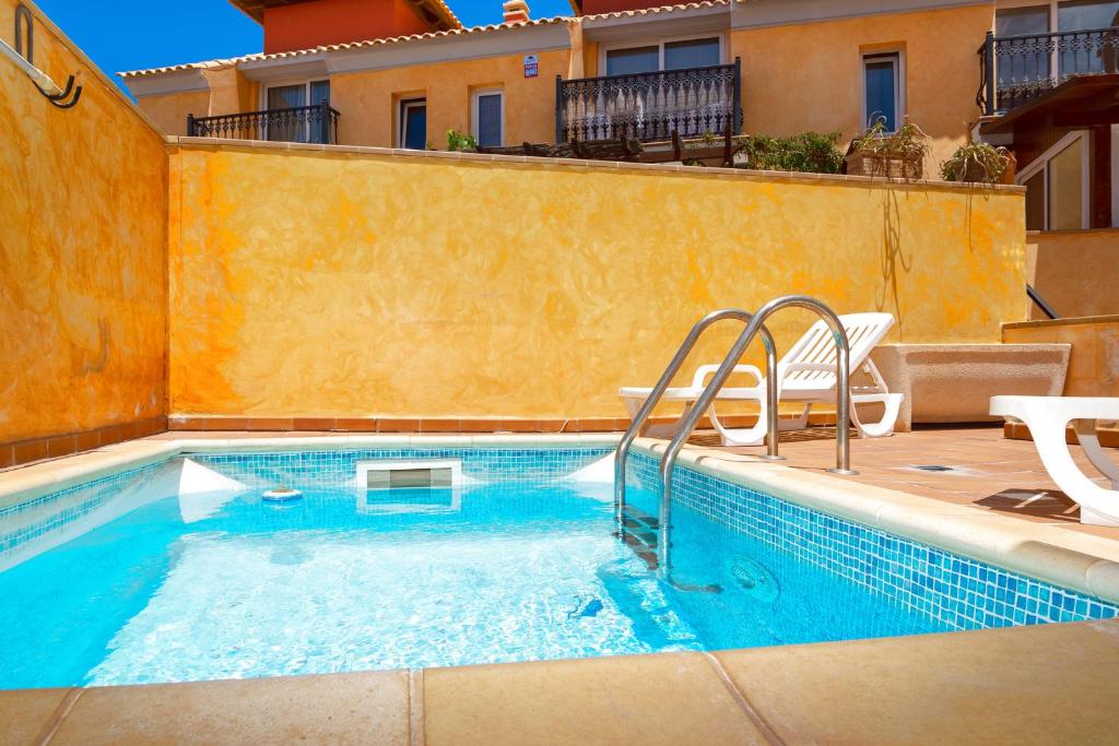 a swimming pool in front of a building at Casa Dorada in La Oliva
