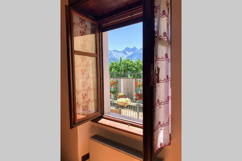 a window with a view of a mountain at Il nido in Brusson