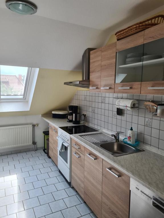 a kitchen with a sink and a stove top oven at Ferienwohnung Fiehn in Schwedt