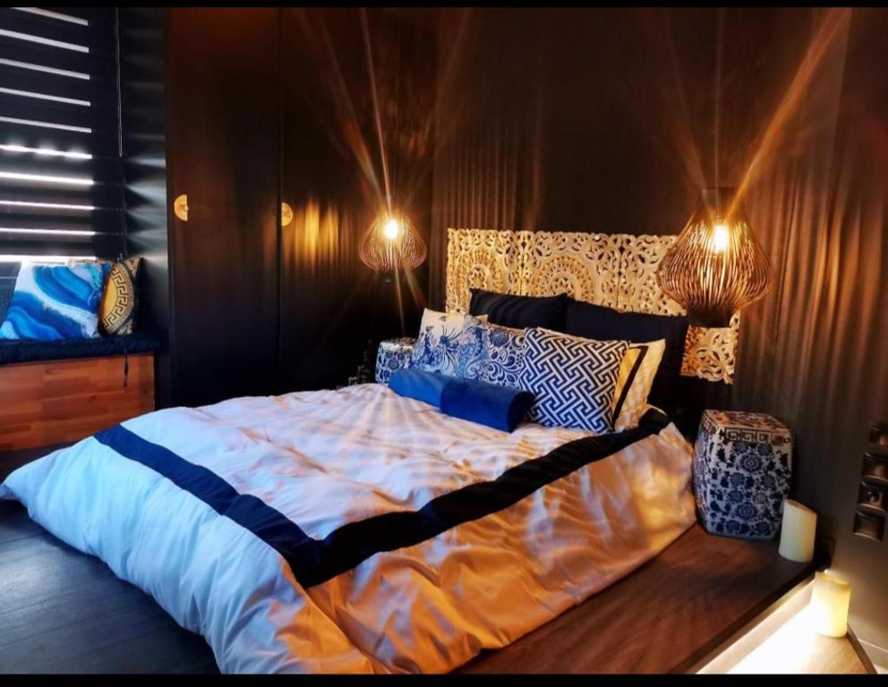 a bedroom with a large bed with blue and white sheets at Accessible Luxury in Artemida