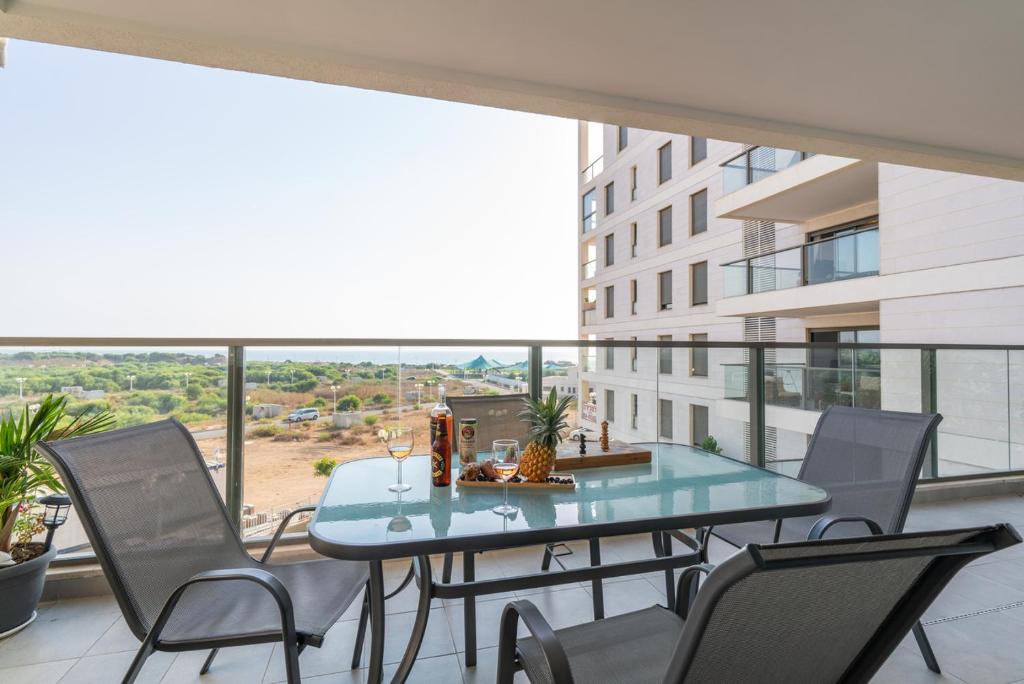a table and chairs on a balcony with a view at Achziv Beach Life with Stunning Sea Views by Sea N' Rent in Nahariyya