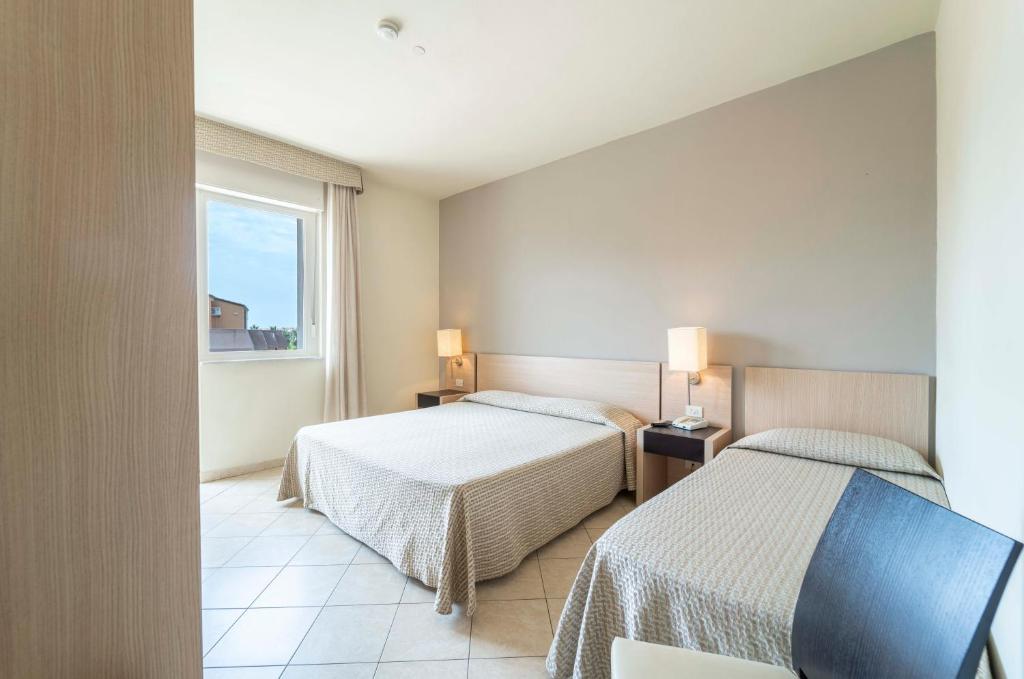 Postel nebo postele na pokoji v ubytování Hotel San Giuan