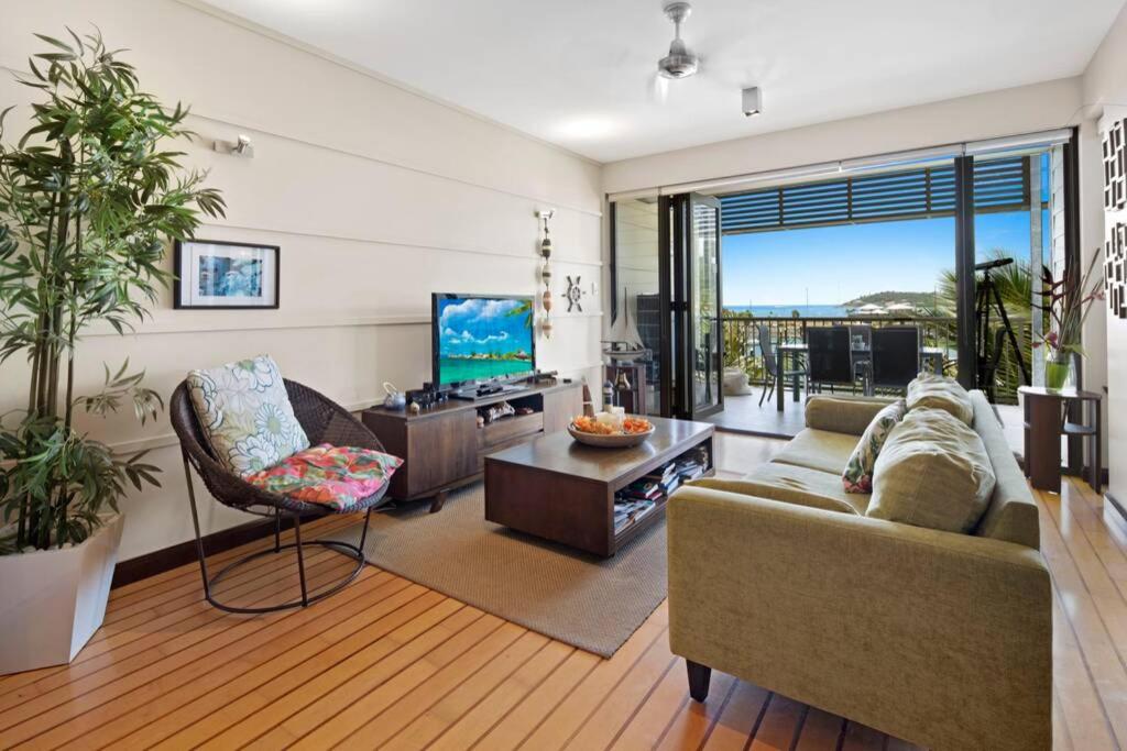 a living room with a couch and a tv at 20 S at the Marina in Airlie Beach