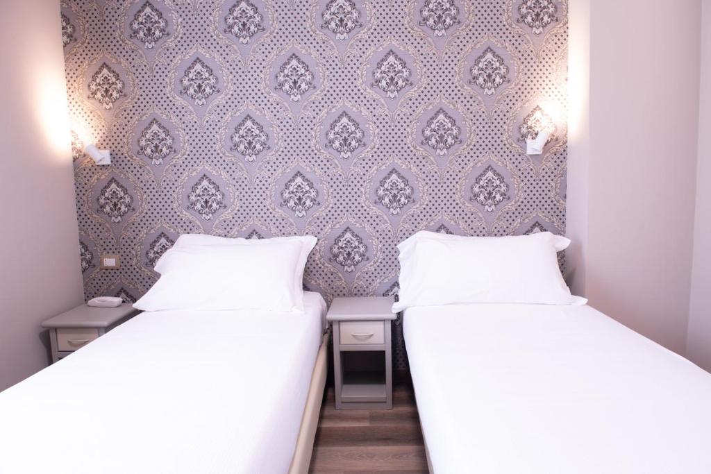 Postel nebo postele na pokoji v ubytování Hotel Della Rosa