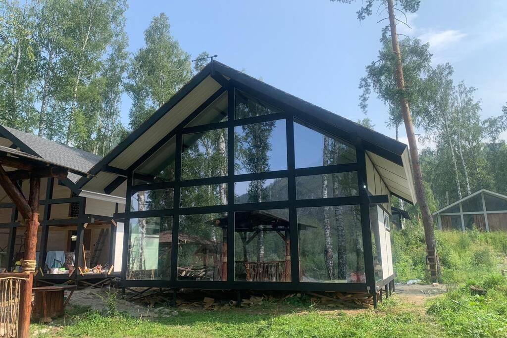 a glass house in the middle of a forest at Altai VLDS 11 in Manzherok