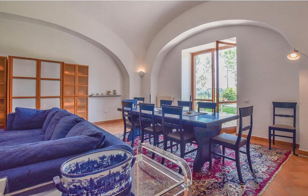 Appartamenti Villa Ortensia في Alvignano: غرفة معيشة مع طاولة وأريكة زرقاء
