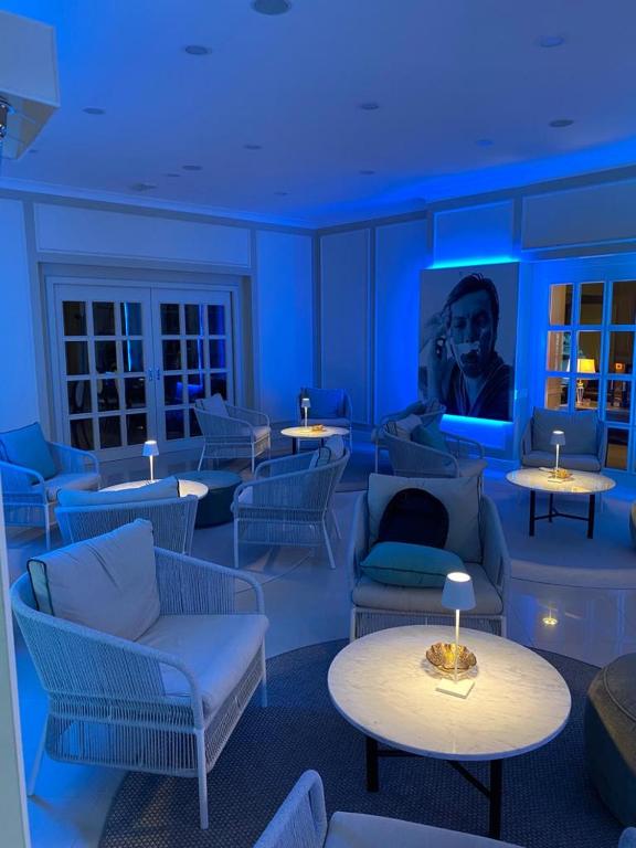 a room with couches and tables and a tv at Hotel Miramare & Spa in Sestri Levante