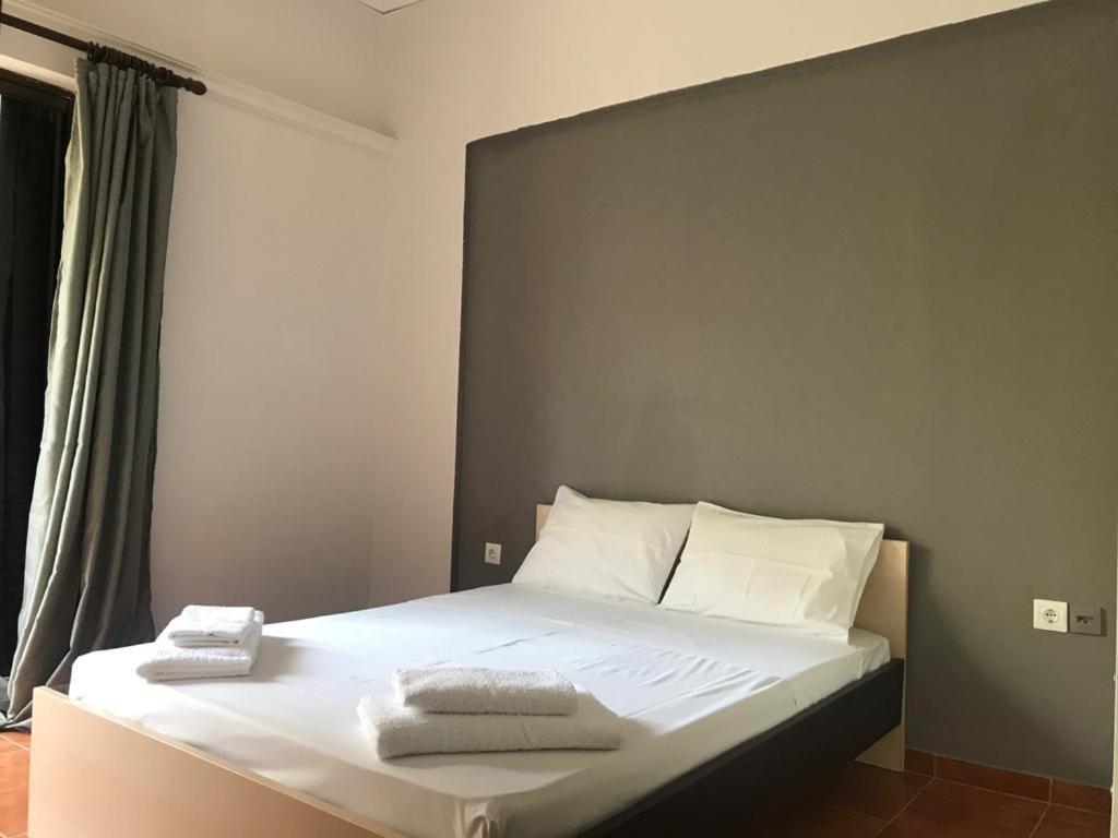 a bedroom with a bed with two towels on it at Amalthia Hotel Apartments in Rethymno