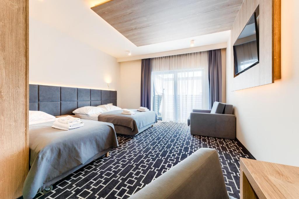 Postel nebo postele na pokoji v ubytování Hotel Wena