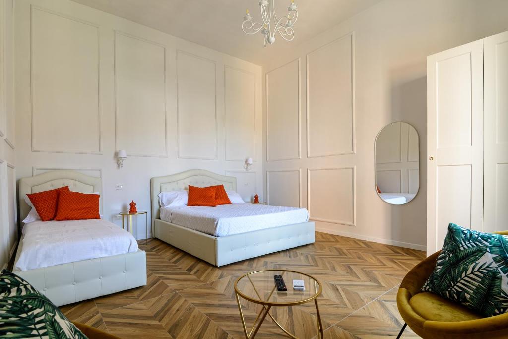 een slaapkamer met 2 bedden en een bank en een tafel bij agropoli luxury home in Agropoli