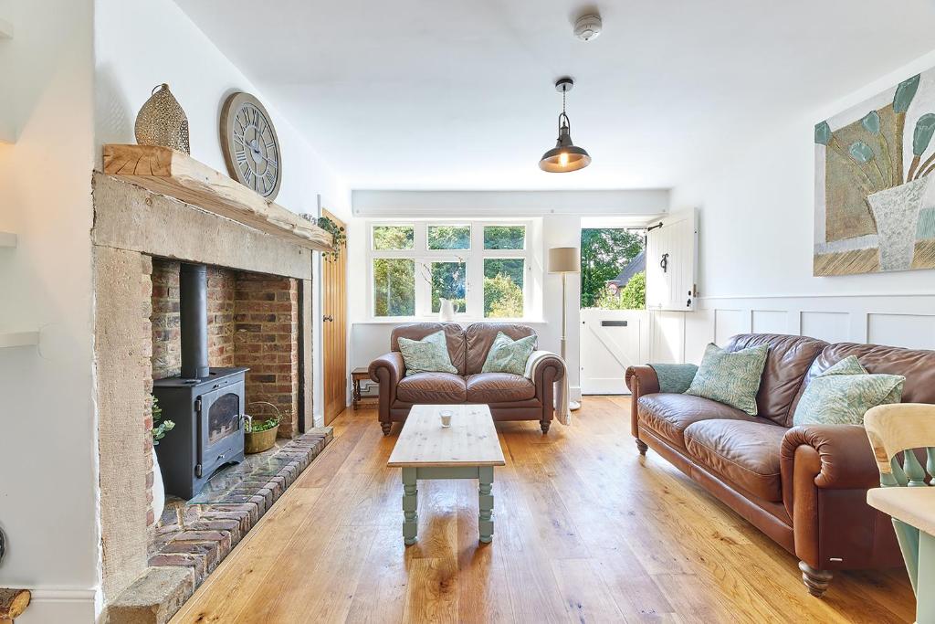 a living room with couches and a fireplace at Host & Stay - Waterleap Cottage in Ovingham