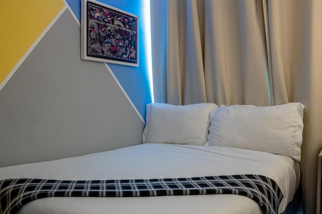 Postel nebo postele na pokoji v ubytování Kubo Hotel