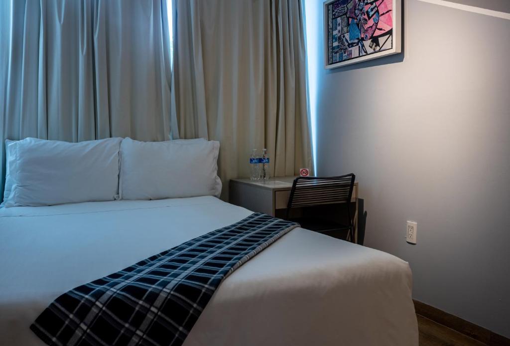 Postel nebo postele na pokoji v ubytování Kubo Hotel