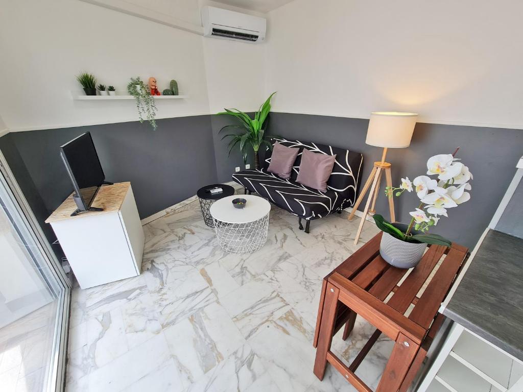 a living room with a couch and a table at GregBnb-com - T2 Pleine Ville - CLIMATISE - BALCON - 1 in Toulon