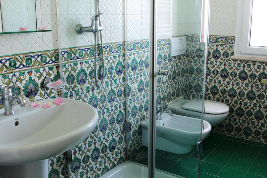 a bathroom with a sink and a toilet at Torre Bennistra in Scopello