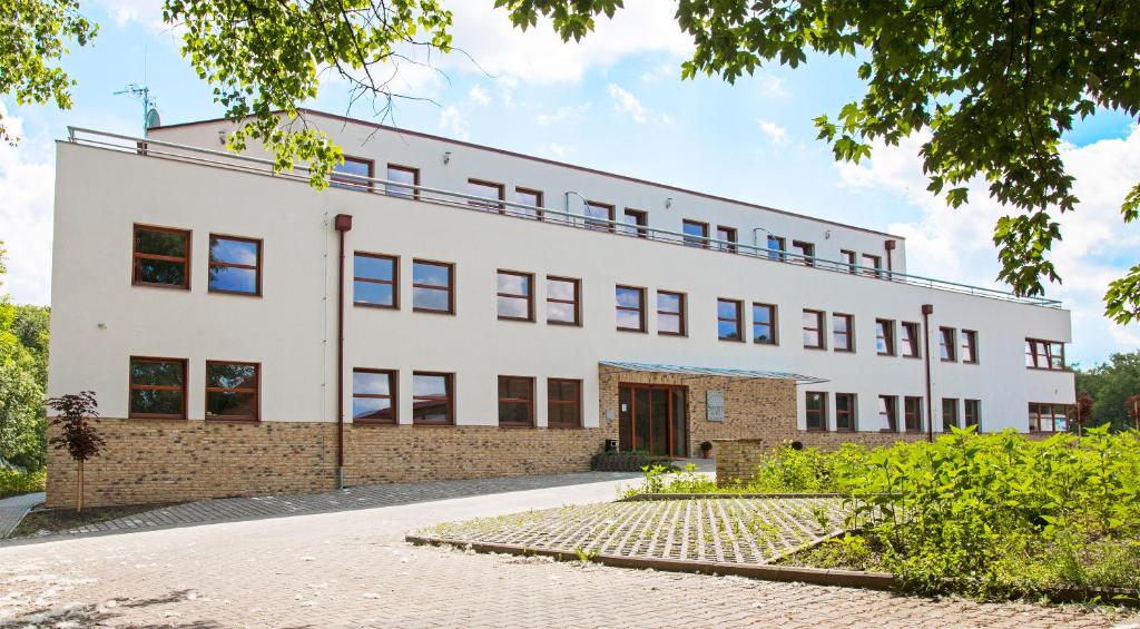 an external view of a white building at Sporthotel Hostivice in Hostivice