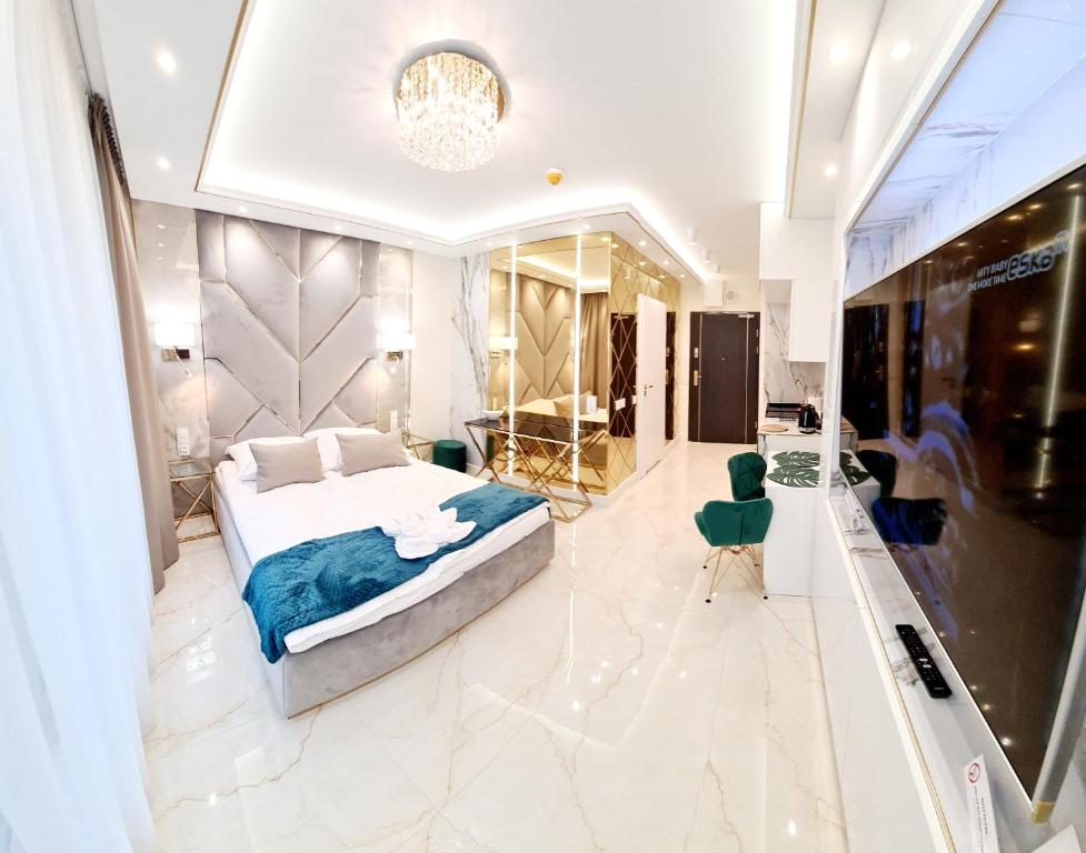 a large bedroom with a bed and a mirror at Adonis Beach in Świnoujście