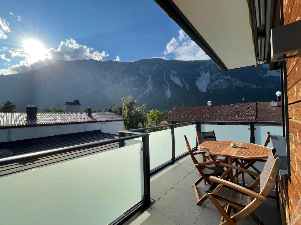 a balcony with a table and a view of mountains at Ferienwohnung Caroline in Ötztal-Bahnhof