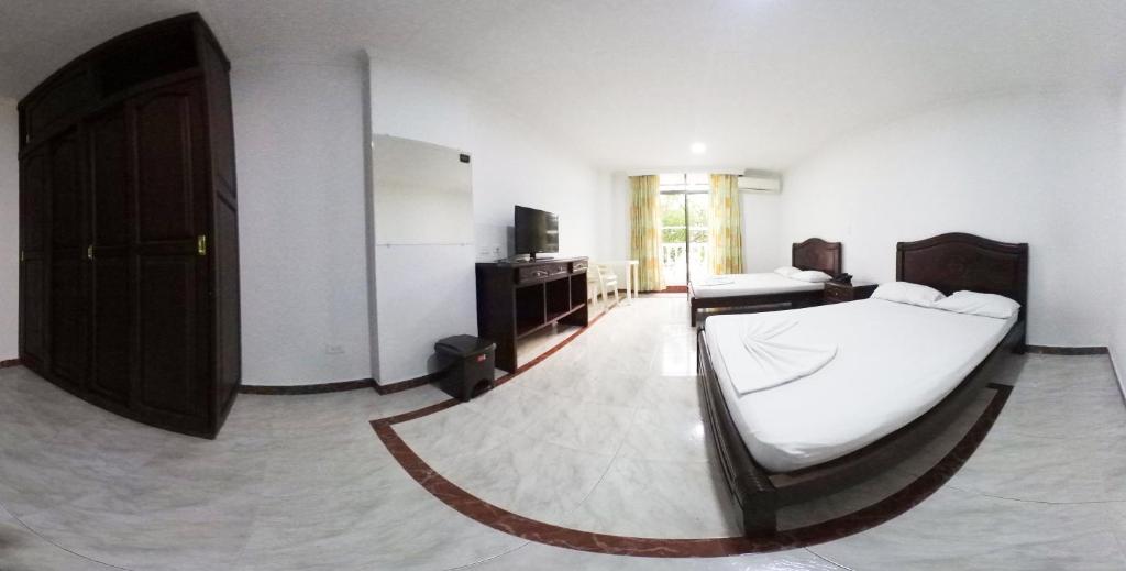 Postel nebo postele na pokoji v ubytování Zahira Hotel Melgar