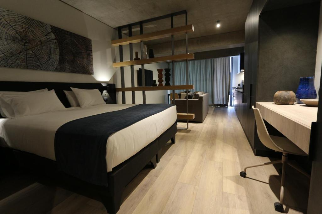 a hotel room with a bed and a desk at Nucleo Mayor Apart in Santiago