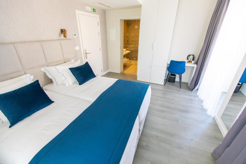 Postel nebo postele na pokoji v ubytování Hotel Mondego