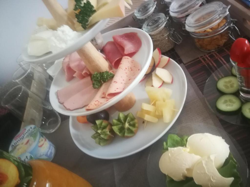 dos platos de diferentes tipos de comida en una mesa en Einzelzimmer *Am Bronnwiesle*, en Deggingen
