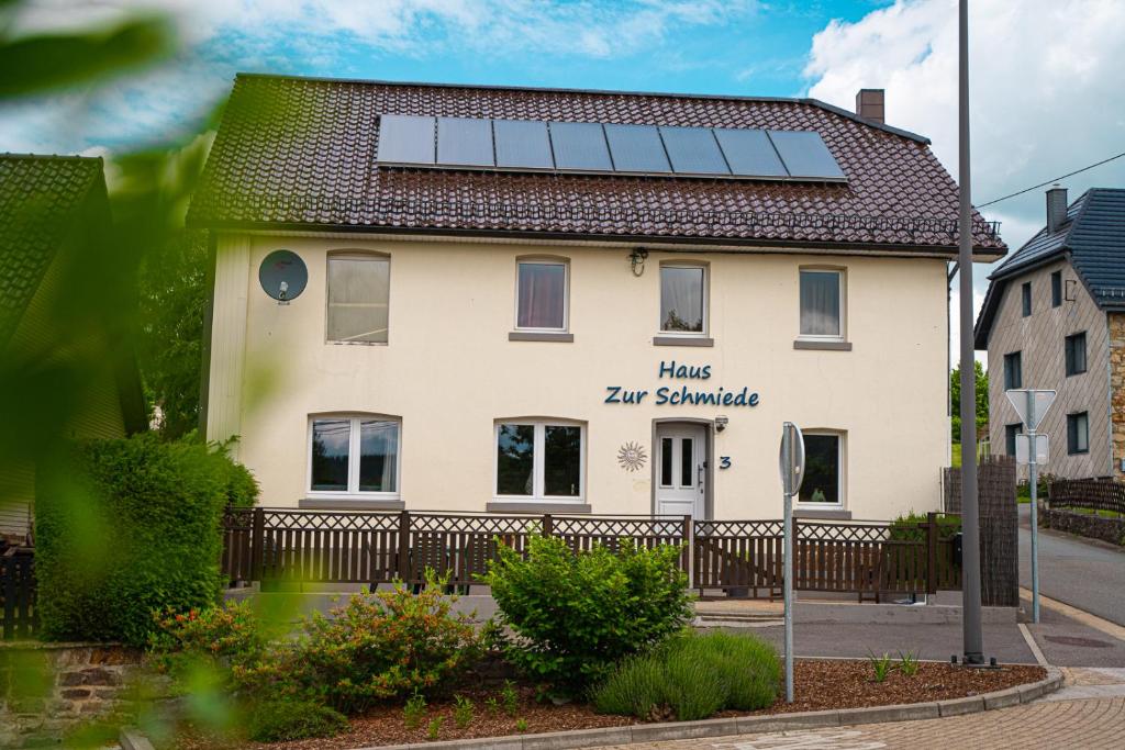 a house with solar panels on the roof at Haus Zur Schmiede in Recht