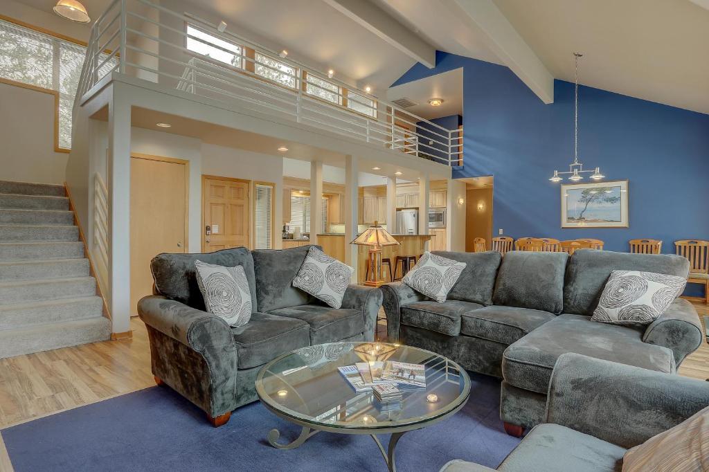 a living room with a couch and a glass table at 1 Colonial in Sunriver