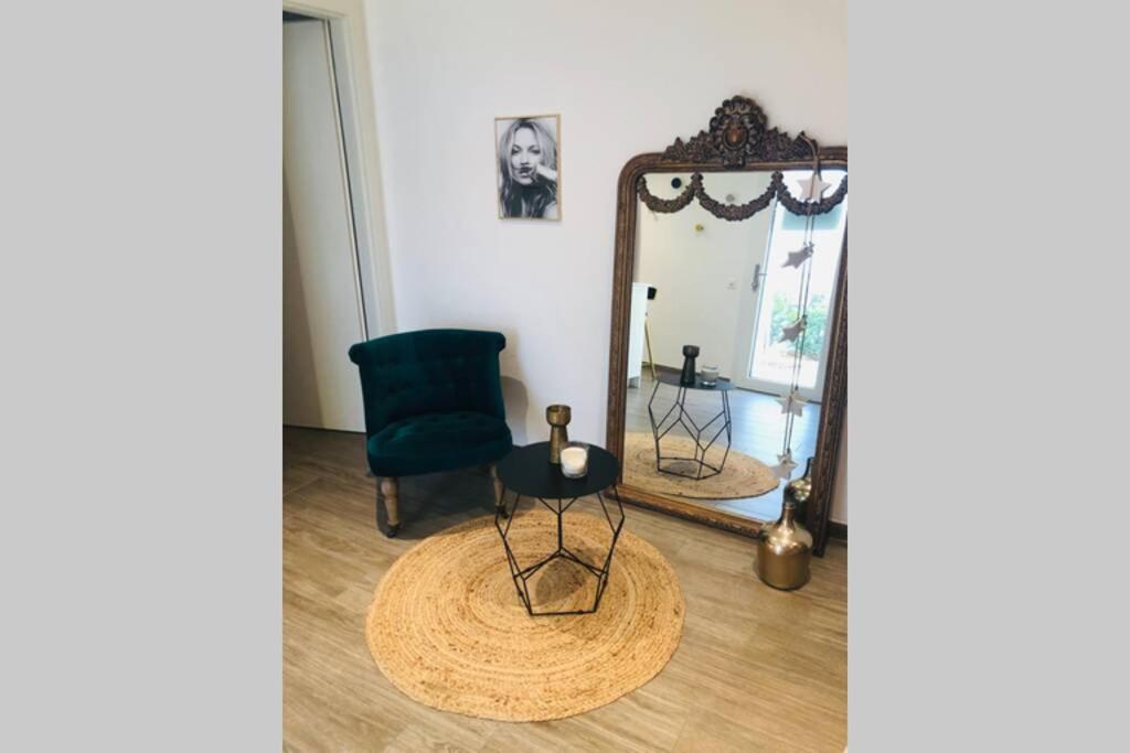a mirror and a chair in a room at Beautiful Cocoon in Neuchâtel
