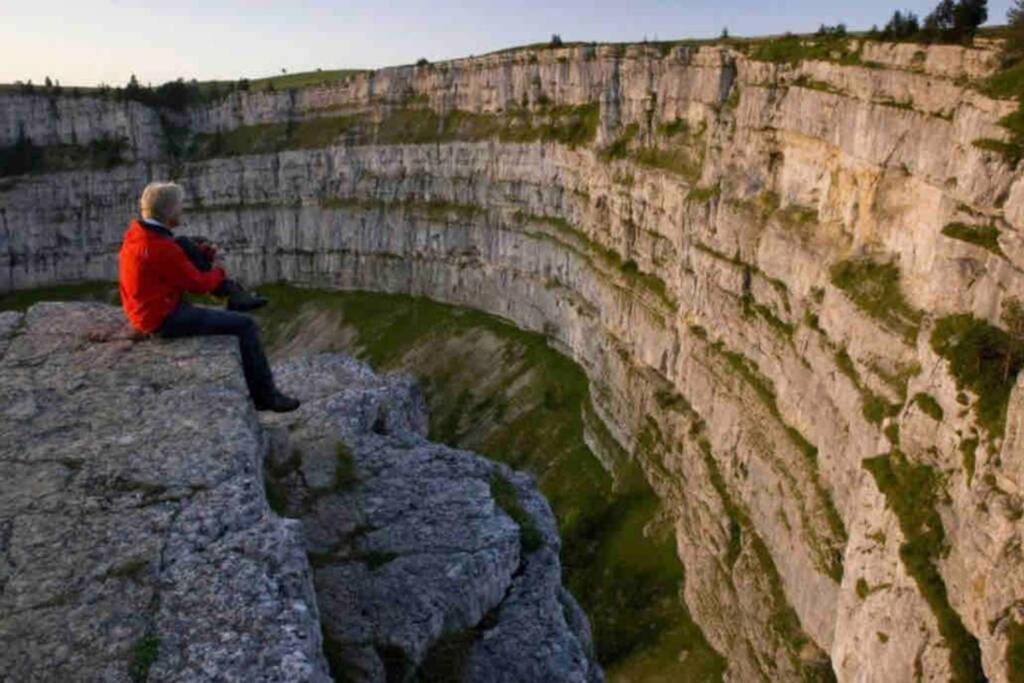 a man sitting on a rock near a bridge at Beautiful Cocoon in Neuchâtel