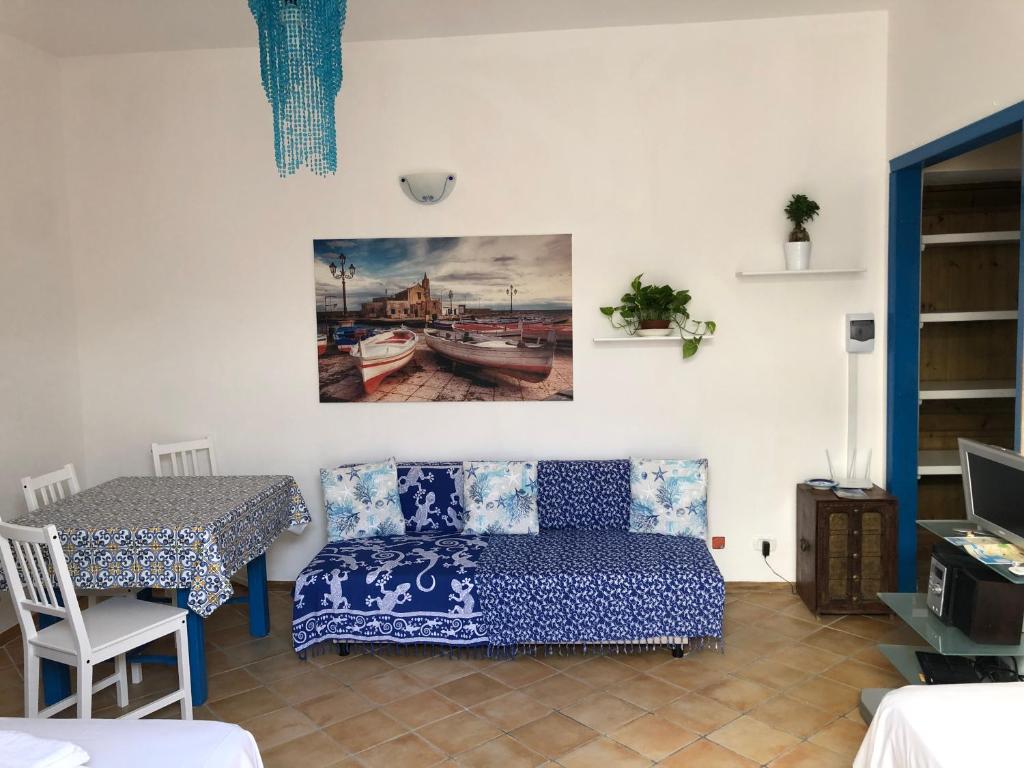 a living room with a couch and a table at Il Cortiletto - Lipari CENTRO in Lipari