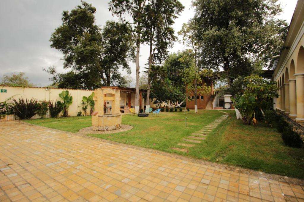 a yard with a house and a brick driveway at Hacienda Molino Santo Domingo in San Cristóbal de Las Casas
