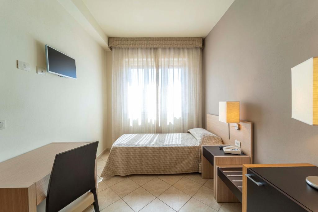 Postel nebo postele na pokoji v ubytování Hotel San Giuan