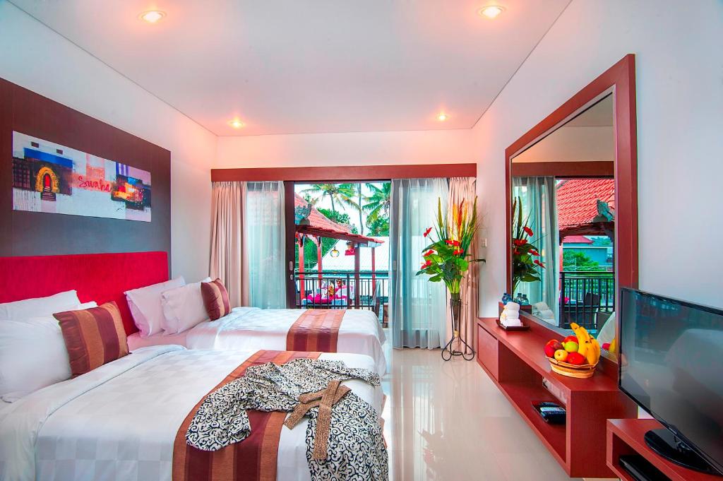 Postel nebo postele na pokoji v ubytování The Swaha Ubud Hotel