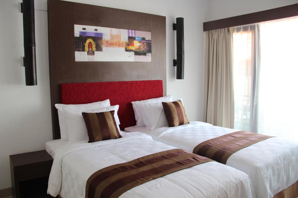 Postel nebo postele na pokoji v ubytování The Swaha Ubud Hotel