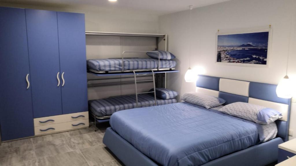 a bedroom with two bunk beds and a blue cabinet at Maria e Antonio Blu in Castellammare di Stabia