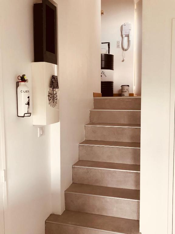 a staircase in a house with concrete steps at L’échappée Bulles in Épernay