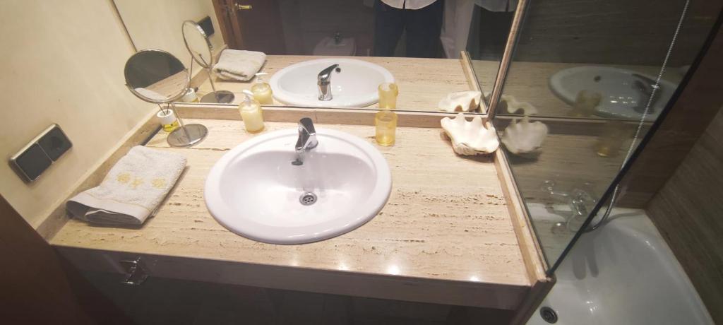 a bathroom counter with a sink and a mirror at Blanes Apartamento S'Abanell central park in Blanes